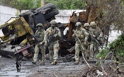 Russian servicemen patrol the destroyed part of the Ilyich Iron and Steel Works in Ukraine's port city of Mariupol on May 18, 2022. (Olga MALTSEVA / AFP)