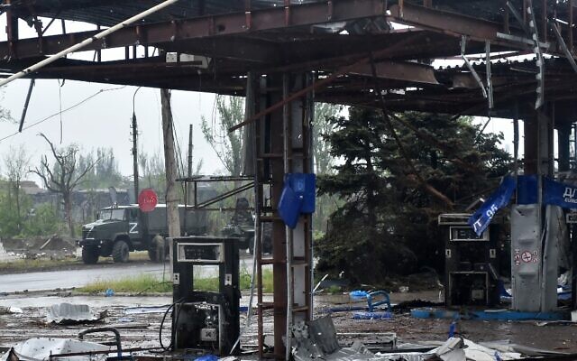 A Russian military truck painted with the letter Z is seen behind a destroyed gas station in Ukraine's port city of Mariupol on May 18, 2022. (Olga MALTSEVA / AFP) A Russian military truck painted with the letter Z is seen behind a destroyed gas station in Ukraine's port city of Mariupol on May 18, 2022. (Olga MALTSEVA / AFP)