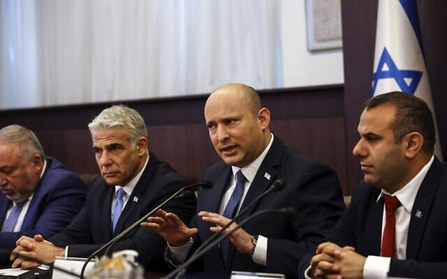 Prime Minister Naftali Bennett (2nd-R) and Foreign Minister Yair Lapid (2nd-L) attend the weekly cabinet meeting at the Prime Minister's Office in Jerusalem on May 22, 2022. (Ronen Zvulun/Pool/AFP) Prime Minister Naftali Bennett (2nd-R) and Foreign Minister Yair Lapid (2nd-L) attend the weekly cabinet meeting at the Prime Minister's Office in Jerusalem on May 22, 2022. (Ronen Zvulun/Pool/AFP)