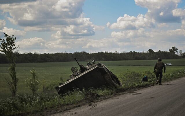 A Ukrainian serviceman walks next to a damaged Ukrainian armored vehicle outside the city of Lysychansk in the eastern region of Donbas, on May 23, 2022, amid the Russian invasion of Ukraine. (Aris Messinis/AFP) A Ukrainian serviceman walks next to a damaged Ukrainian armored vehicle outside the city of Lysychansk in the eastern region of Donbas, on May 23, 2022, amid the Russian invasion of Ukraine. (Aris Messinis/AFP)