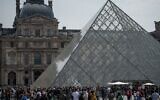 Visitors outside the Louvre Museum, in Paris on April 29, 2022. (AFP)
