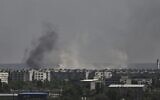 Smoke and dirt rise from the city of Severodonetsk, during shelling in the eastern Ukrainian region of Donbas, on May 26, 2022, amid Russia's military invasion launched on Ukraine. (Aris Messinis/AFP)