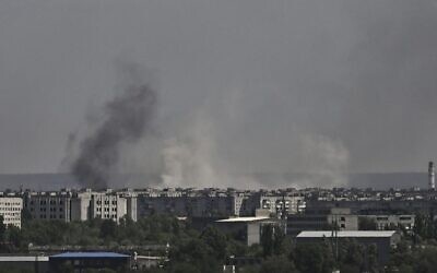 Smoke and dirt rise from the city of Severodonetsk, during shelling in the eastern Ukrainian region of Donbas, on May 26, 2022, amid Russia's military invasion launched on Ukraine. (Aris Messinis/AFP)