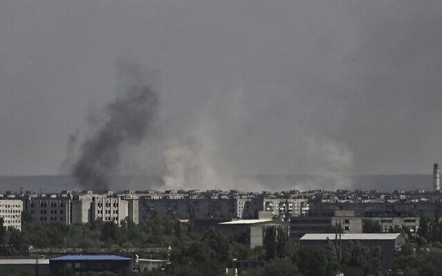 Smoke and dirt rise from the city of Severodonetsk, during shelling in the eastern Ukrainian region of Donbas, on May 26, 2022, amid Russia's military invasion launched on Ukraine. (Aris Messinis/AFP)