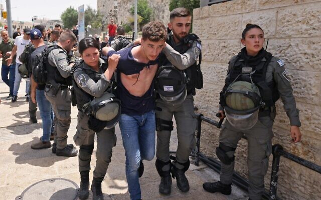 Israeli security forces detain a Palestinian at the Damascus Gate to Jerusalem's Old City amid Jerusalem Day celebrations on May 29, 2022. (Ahmad Gharabli/AFP) Israeli security forces detain a Palestinian at the Damascus Gate to Jerusalem's Old City amid Jerusalem Day celebrations on May 29, 2022. (Ahmad Gharabli/AFP)