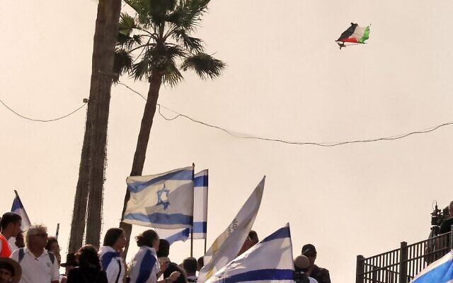 Israelis watch as a drone carrying a Palestinian flag flies over them outside the Damascus Gate to Jerusalem's old City on May 29, 2022, as Israel marks Jerusalem Day. (Hazem Bader/AFP) Israelis watch as a drone carrying a Palestinian flag flies over them outside the Damascus Gate to Jerusalem's old City on May 29, 2022, as Israel marks Jerusalem Day. (Hazem Bader/AFP)