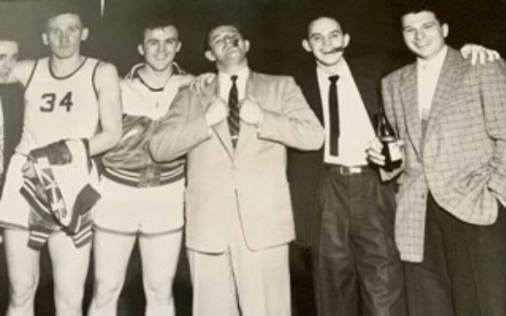 Herbie Cohen, his players and coaches celebrate victory in the Army’s European Basektball League in Germany circa 1953. (Courtesy of Rich Cohen)