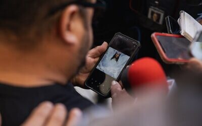 Jacinto Cazares shows a photo of his daughter who was killed at Robb Elementary School, 10-year-old Jackie Cazares, to reporters following a press conference on May 25, 2022 in Uvalde, Texas. (Jordan Vonderhaar / Getty Images via AFP)