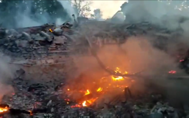 Screen grab of a video, which cannot be verified, that apparently shows the burning rubble at the site of the school in Bilohorivka, May 8, 2022. (Screen grab/twitter)