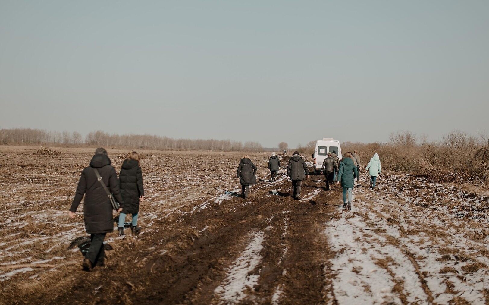 Civilians from the rescue convoy from Yaroslavka, Ukraine, walk on foot to lighten the loads of vehicles forced to travel through muddy fields, March 20, 2022. The roads were occupied by Russian soldiers. (Klara Lisinski/ Dorcas Kauffman) Civilians from the rescue convoy from Yaroslavka, Ukraine, walk on foot to lighten the loads of vehicles forced to travel through muddy fields, March 20, 2022. The roads were occupied by Russian soldiers. (Klara Lisinski/ Dorcas Kauffman)