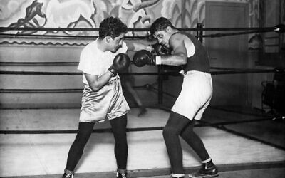 Tunisian Jewish boxer Victor Perez, left, is featured on the new podcast 'Holocaust Histories.' (Jeff Dickson/AFP via Getty Images/ via JTA)
