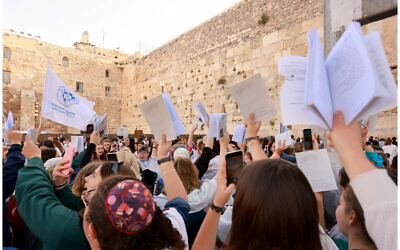 Women hold a prayer service at the Western Wall as demonstrators protest against them on May 2, 2022. (Women of the Wall)