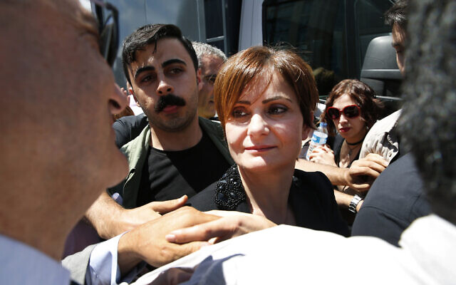 Canan Kaftancioglu, Turkey's opposition Republican People's Party (CHP) Istanbul provincial chairwoman is surrounded by supporters outside a court in Istanbul, July 18, 2019. (AP Photo/Lefteris Pitarakis)