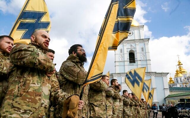 Ukrainian volunteers with the right-wing paramilitary Azov National Corps with their flags demonstrate their strength, during Ukrainian Volunteer Day in Kyiv, Ukraine, March 14, 2020. (AP Photo/Efrem Lukatsky) Ukrainian volunteers with the right-wing paramilitary Azov National Corps with their flags demonstrate their strength, during Ukrainian Volunteer Day in Kyiv, Ukraine, March 14, 2020. (AP Photo/Efrem Lukatsky)