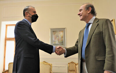 Enrique Mora, a leading European Union diplomat, right, with Iranian Foreign Minister Hossein Amir-Abdollahian at the start of their meeting, in Tehran, Iran, March 27, 2022. (Iranian Foreign Ministry via AP)