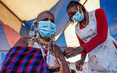 Illustrative image: a woman receives a coronavirus vaccine in Kimana, southern Kenya on Aug. 28, 2021. While vaccines have been rolled out in Africa, boosters are lacking there, as in many other parts of the world. (AP Photo/Brian Inganga, File)