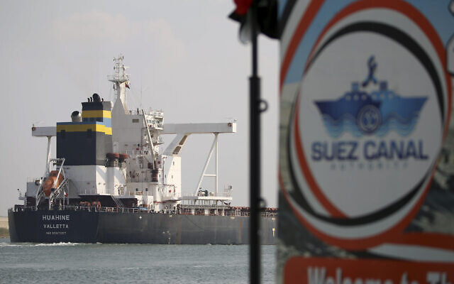 A cargo ship sails through the town of Ismailia, Egypt, March 30, 2021. (AP Photo/Ayman Aref, File)