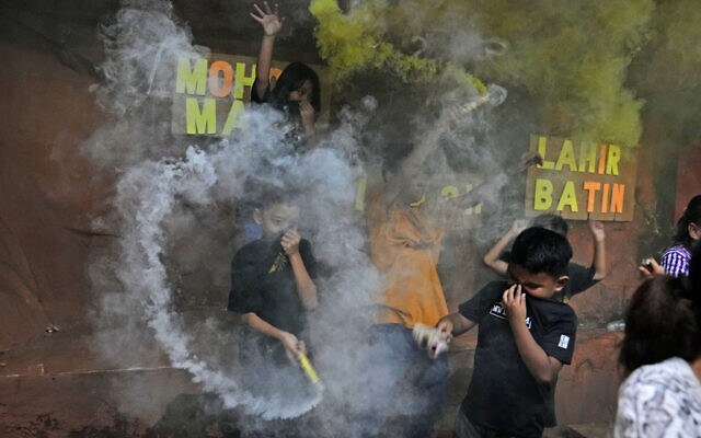 Young boys light smoke bombs as they celebrate the eve of Eid al-Fitr, the holiday marking the end of the holy fasting month of Ramadan, in Jakarta, Indonesia, May 1, 2022. (AP Photo/Dita Alangkara) Young boys light smoke bombs as they celebrate the eve of Eid al-Fitr, the holiday marking the end of the holy fasting month of Ramadan, in Jakarta, Indonesia, May 1, 2022. (AP Photo/Dita Alangkara)
