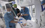 Karina Andreiko, a 5-year-old Ukrainian girl, is about to undergo heart surgery by a team led by Dr. Sagi Assa, head of invasive pediatric cardiology, from the Save A Child's Heart non-profit organization, at the Wolfson Medical center in Holon, near Tel Aviv, May 2, 2022. (AP Photo/ Ariel Schalit)
