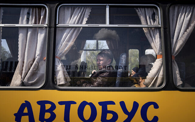 Women wait in a bus at a center for displaced people in Zaporizhzhia, Ukraine, Monday, May 2, 2022. The sign reads: "Bus." (AP Photo/Evgeniy Maloletka) Women wait in a bus at a center for displaced people in Zaporizhzhia, Ukraine, Monday, May 2, 2022. The sign reads: "Bus." (AP Photo/Evgeniy Maloletka)