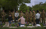 Israeli soldiers and family members of fallen soldiers gather for a ceremony marking Memorial Day at a military cemetery in Tel Aviv, May 4, 2022. (AP Photo/Oded Balilty)