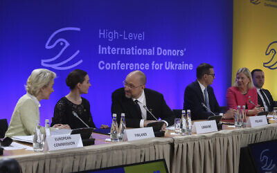 Ukrainian Prime Minister Denys Szmyhal, center, talks to President of the European Commission Ursula von der Leyen, left, and Prime Minister of Finland, Sanna Marin, 2nd left, at the High-Level International Donor's Conference for Ukraine at the National Stadium in Warsaw, Poland, on May 5, 2022. (AP Photo/Michal Dyjuk)