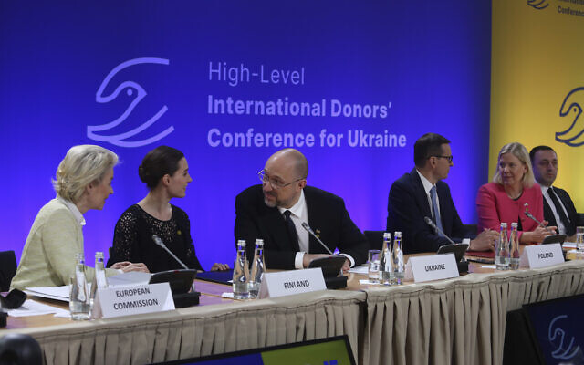 Ukrainian Prime Minister Denys Szmyhal, center, talks to President of the European Commission Ursula von der Leyen, left, and Prime Minister of Finland, Sanna Marin, 2nd left, at the High-Level International Donor's Conference for Ukraine at the National Stadium in Warsaw, Poland, on May 5, 2022. (AP Photo/Michal Dyjuk) Ukrainian Prime Minister Denys Szmyhal, center, talks to President of the European Commission Ursula von der Leyen, left, and Prime Minister of Finland, Sanna Marin, 2nd left, at the High-Level International Donor's Conference for Ukraine at the National Stadium in Warsaw, Poland, on May 5, 2022. (AP Photo/Michal Dyjuk)