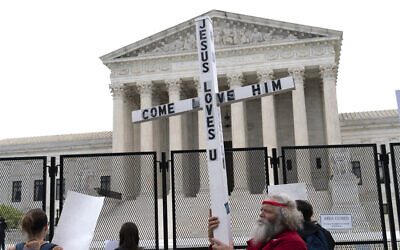 A demonstrator holding a cross protests outside of the U.S. Supreme Court, Washington DC, May 5, 2022. (AP/Jose Luis Magana, File)