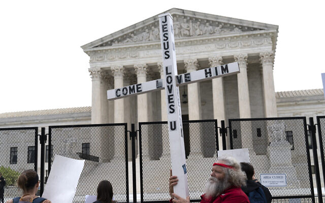 A demonstrator holding a cross protests outside of the U.S. Supreme Court, Washington DC, May 5, 2022. (AP/Jose Luis Magana, File) A demonstrator holding a cross protests outside of the U.S. Supreme Court, Washington DC, May 5, 2022. (AP/Jose Luis Magana, File)