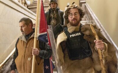 Supporters of President Donald Trump, including Aaron Mostofsky, right, who is identified in his arrest warrant, walk down the stairs outside the Senate Chamber in the US Capitol, in Washington, on January 6, 2021. (AP Photo/Manuel Balce Ceneta, File)