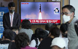People watch a TV showing a file image of North Korea's missile launch during a news program at the Seoul Railway Station in Seoul, South Korea, on May 7, 2022. (AP Photo/Ahn Young-joon)