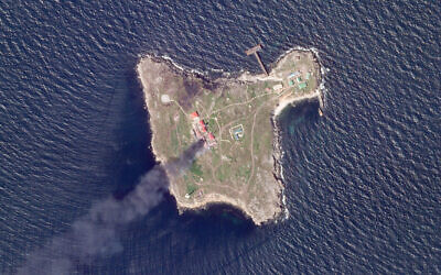 This satellite image taken by Planet Labs PBC shows thick black smoke rising after a suspected Ukrainian drone strike on Russian positions on Snake Island, Ukraine, in the Black Sea, May 6, 2022. (Planet Labs PBC via AP)