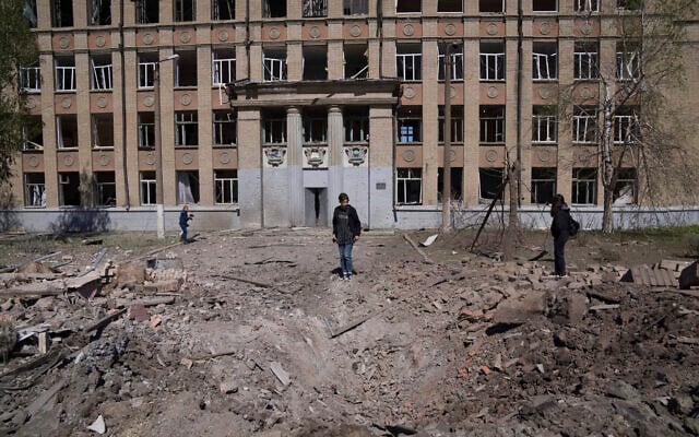 A woman looks on a crater of an explosion after Russian airstrike in Kostyantynivka, Donetsk region, Ukraine, May 7, 2022. Evgeniy Maloletka/ AP) A woman looks on a crater of an explosion after Russian airstrike in Kostyantynivka, Donetsk region, Ukraine, May 7, 2022. Evgeniy Maloletka/ AP)