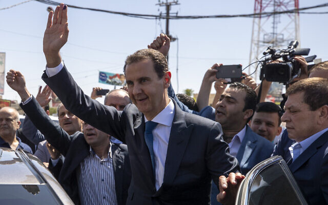Syrian President Bashar Assad, center, waves to his supporters at a polling station during the Presidential elections in the town of Douma, in the eastern Ghouta region, near the Syrian capital Damascus, Syria, May 26, 2021. (AP Photo/Hassan Ammar, file) Syrian President Bashar Assad, center, waves to his supporters at a polling station during the Presidential elections in the town of Douma, in the eastern Ghouta region, near the Syrian capital Damascus, Syria, May 26, 2021. (AP Photo/Hassan Ammar, file)