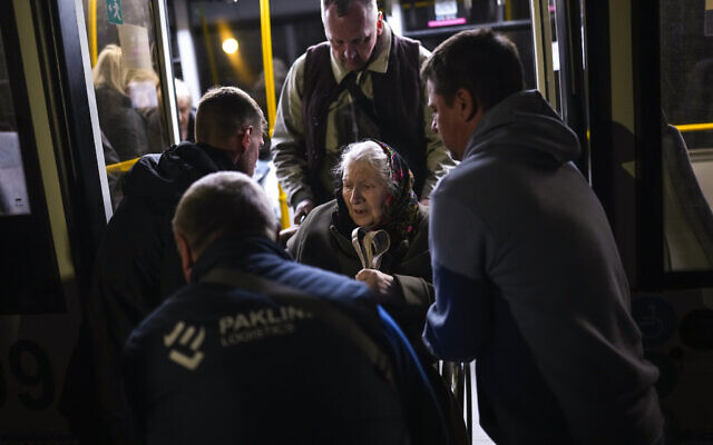 A woman who fled from the Azovstal steel plant in Mariupol is helped from a bus upon her arrival at a reception center for displaced people in Zaporizhzhia, Ukraine, on May 8, 2022. (Francisco Seco/AP) A woman who fled from the Azovstal steel plant in Mariupol is helped from a bus upon her arrival at a reception center for displaced people in Zaporizhzhia, Ukraine, on May 8, 2022. (Francisco Seco/AP)