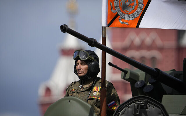 A Russian serviceman stands in a military vehicle rolling during the Victory Day military parade in Moscow, Russia, May 9, 2022, marking the 77th anniversary of the end of World War II. (AP Photo/Alexander Zemlianichenko)