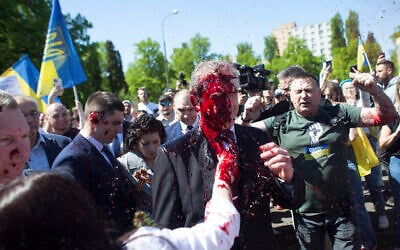 Russian Ambassador to Poland Sergey Andreev is covered with red paint in Warsaw, Poland, May 9, 2022. (AP Photo/Maciek Luczniewski)