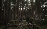 A Ukrainian National Guard soldier sits inside a tank at a position near Kharkiv, Ukraine, May 9, 2022. (Felipe Dana/AP)