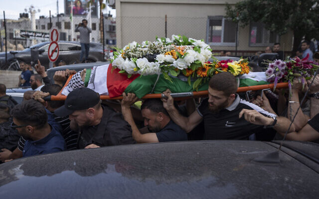 Palestinian mourners carry the body of Shireen Abu Akleh out of the office of Al Jazeera after friends and colleagues paid their respects, in the West Bank city of Ramallah, Wednesday, May 11, 2022. (AP/Nasser Nasser) Palestinian mourners carry the body of Shireen Abu Akleh out of the office of Al Jazeera after friends and colleagues paid their respects, in the West Bank city of Ramallah, Wednesday, May 11, 2022. (AP/Nasser Nasser)