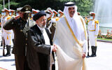 File: In this photo released by the official website of the office of the Iranian Presidency, Qatari Emir Sheikh Tamim bin Hamad Al Thani, right, shakes hands with President Ebrahim Raisi during an official arrival ceremony at the Saadabad Palace in Tehran, Iran, on May 12, 2022. (Iranian Presidency Office via AP)