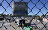 Workers pump water out of the foundation of the former Champlain Towers South building, Surfside, Florida, May 12, 2022. (AP/Marta Lavandier)