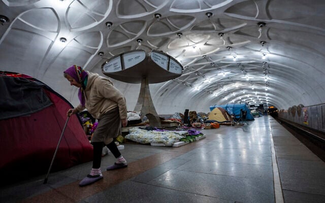An elderly woman walks inside a metro station being used as a bomb shelter in Kharkiv, Ukraine, on May 12, 2022. (AP Photo/Mstyslav Chernov)