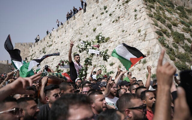 Mourners carry slain Al Jazeera veteran journalist Shireen Abu Akleh from her funeral in the Old City of Jerusalem to the cemetery, Friday, May 13, 2022.  (AP Photo/Ariel Schalit)