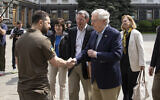 Ukrainian President Volodymyr Zelenskyy, left, shakes hands with Senate Minority Leader Mitch McConnell, a Republican from Kentucky, in Kyiv, Ukraine, May 14, 2022. (Ukrainian Presidential Press Office via AP)