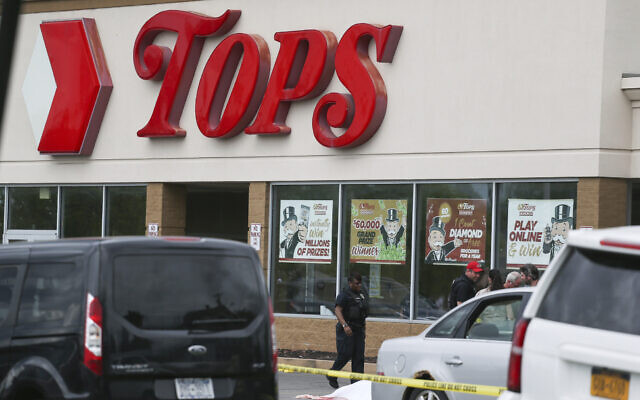 A crowd gathers as police investigate after a shooting at a supermarket on May 14, 2022, in Buffalo, New York. (AP Photo/Joshua Bessex)
