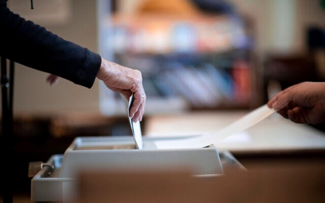 People place their ballots in a ballot box at a polling station in Essen, Germany, May 15, 2022. (Fabian Strauch/ dpa via AP) People place their ballots in a ballot box at a polling station in Essen, Germany, May 15, 2022. (Fabian Strauch/ dpa via AP)