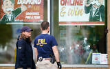 Investigators work the scene of a shooting at a supermarket, in Buffalo, NY, May 16, 2022. (AP Photo/Matt Rourke)