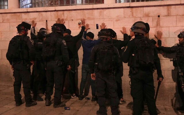 Police detain Palestinians during clashes after the funeral of Walid a-Sharif in East Jerusalem, May 16, 2022 (AP Photo/Mahmoud Illean)