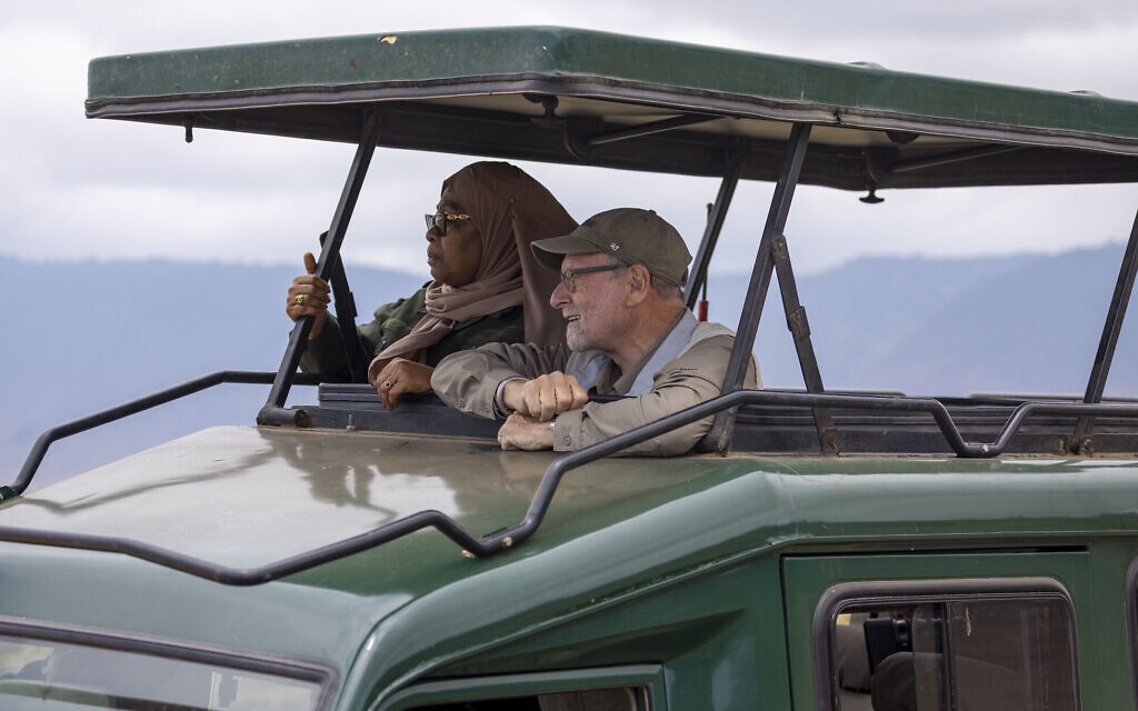 Tanzanian President Samia Suluhu Hassan (left) appears with journalist Peter Greenberg on a safari in Ngorongoro Crater in Tanzania for the television show “The Royal Tour.” (Karen Ballard via AP) Tanzanian President Samia Suluhu Hassan (left) appears with journalist Peter Greenberg on a safari in Ngorongoro Crater in Tanzania for the television show “The Royal Tour.” (Karen Ballard via AP)