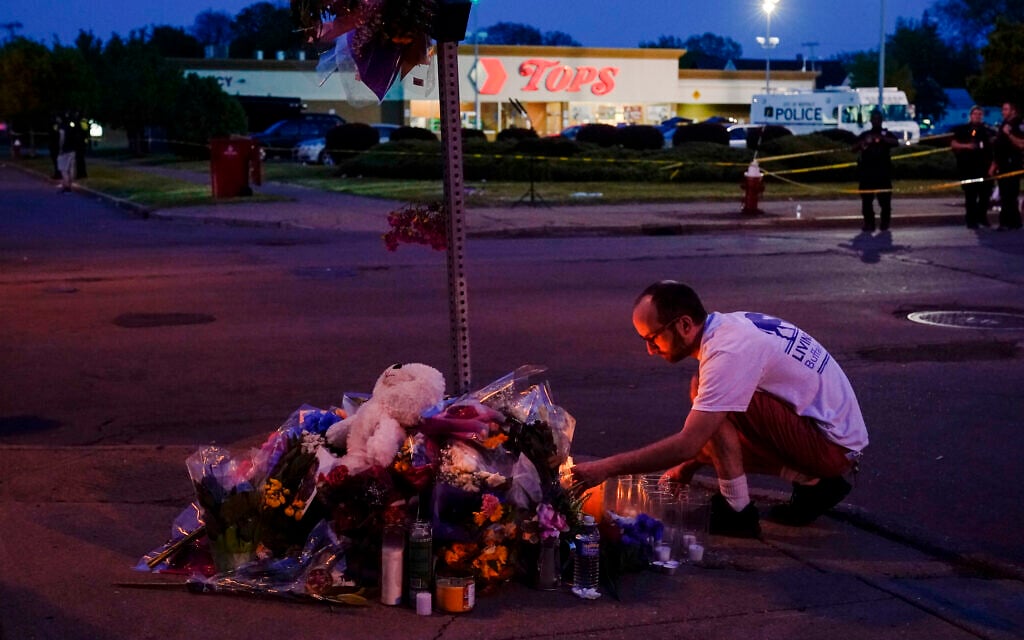 A person pays his respects at a makeshift memorial outside the scene of a shooting at a supermarket in Buffalo, New York, May 15, 2022. (AP/Matt Rourke, File) A person pays his respects at a makeshift memorial outside the scene of a shooting at a supermarket in Buffalo, New York, May 15, 2022. (AP/Matt Rourke, File)